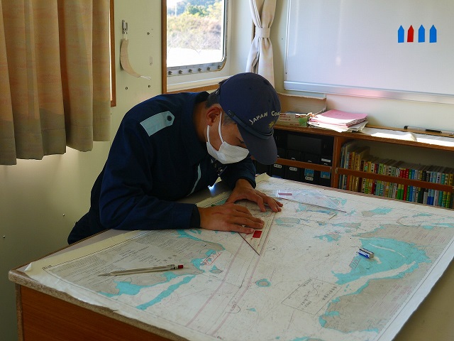 海図にコースラインを引く実習生の様子